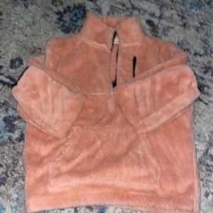 Light pink pullover soft pink, very soft it says medium fits more like a small